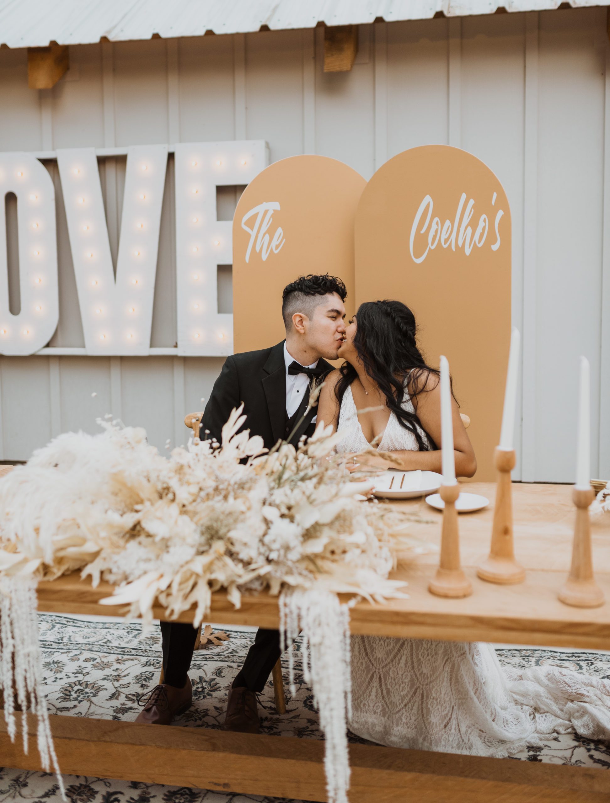 bride and groom sitting at a sweetheart table at westwood barns in california