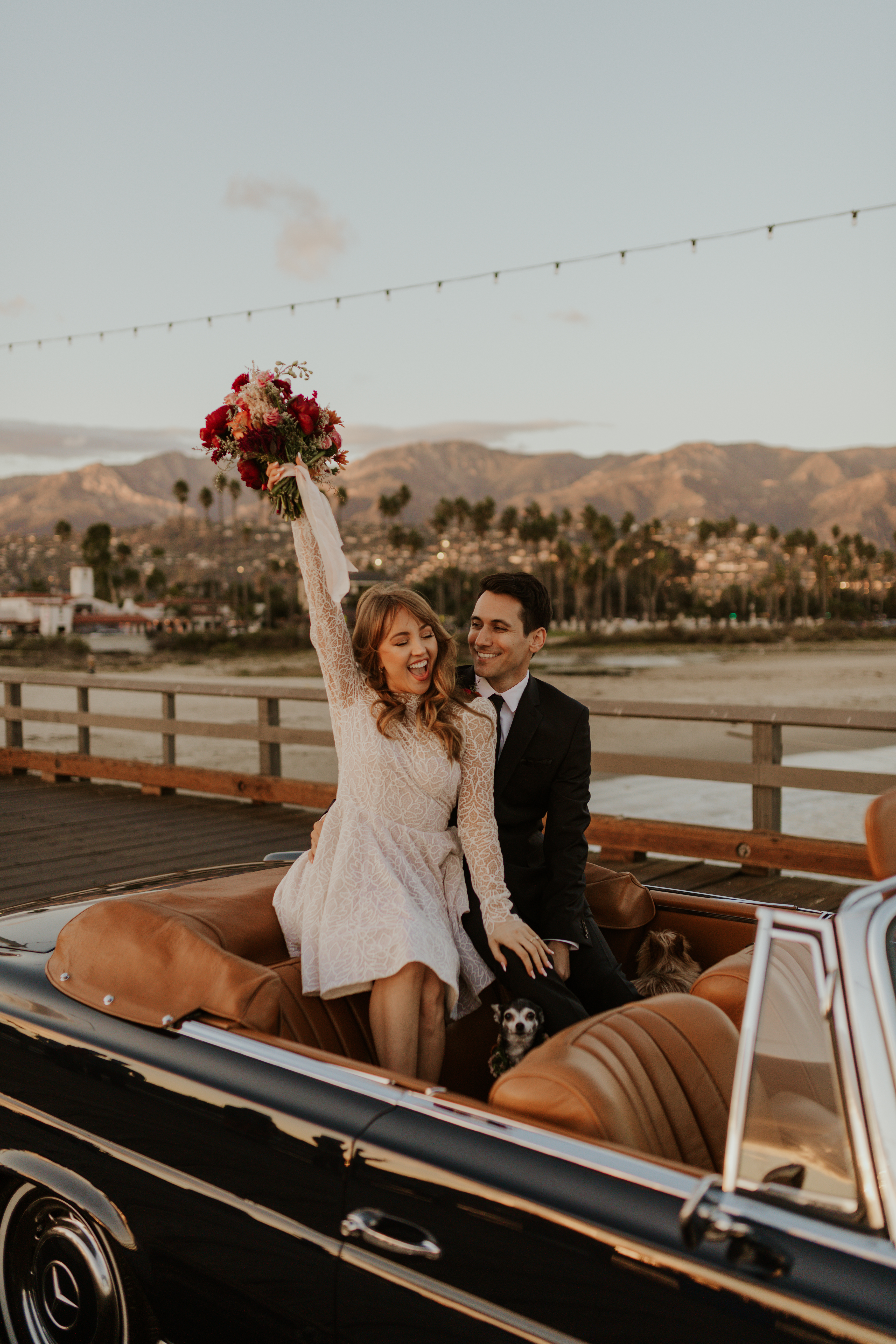 couple sitting on vintage car in santa barbara for their elopement